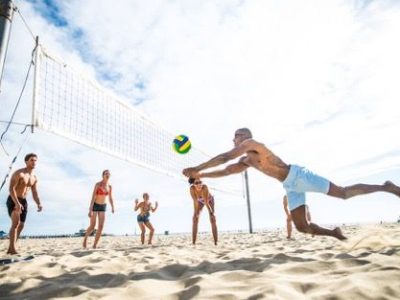 family playing beach volleyball